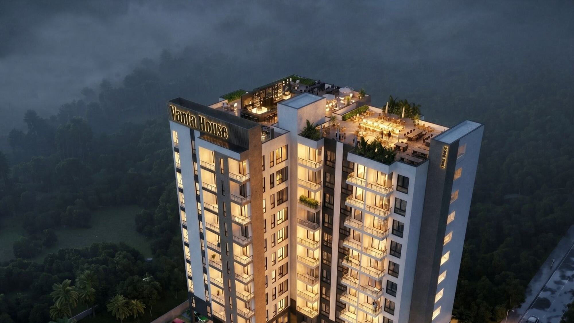 Vanta House apartment tower in Naguru lit at dusk, with its pool and rooftop lounge